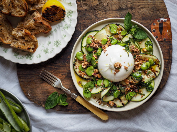 Burrata with grilled and raw courgette, broad beans, burnt lemon vinaigrette and buckwheat dukkah